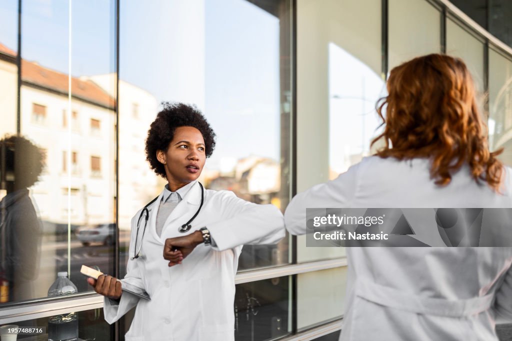 Female Healthcare Professionals Elbow Bumping