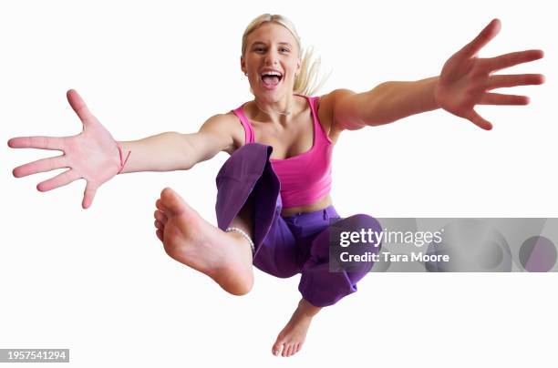 woman jumping for joy - dichterbij komen stockfoto's en -beelden