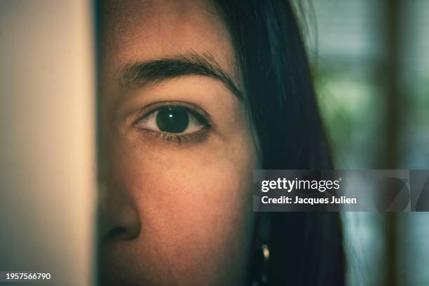 woman peeking through a door - affolé photos et images de collection
