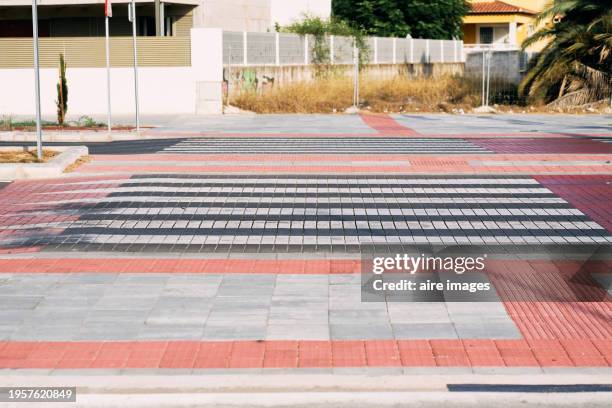 high angle front view of a pedestrian crossing with white lines in the middle of the street without people - speed motion lines to the middle stock pictures, royalty-free photos & images