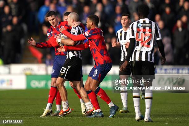 Rangers' Tom Lawrence and Cyriel Dessers attempt to get the ball from St Mirren's Alex Gogic during the cinch Premiership match at The SMISA Stadium,...