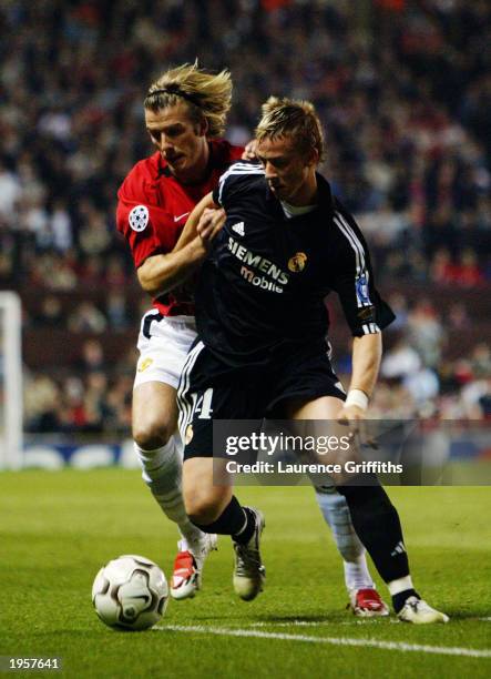 Guti of Real Madrid holds off David Beckham of Manchester United during the UEFA Champions League quarter final, second leg match between Manchester...