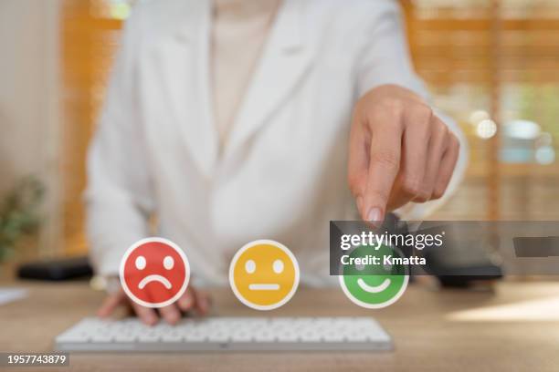 finger of customer touching face emotion icon to give satisfaction rating score. satisfaction survey concept. - customer loyalty stockfoto's en -beelden