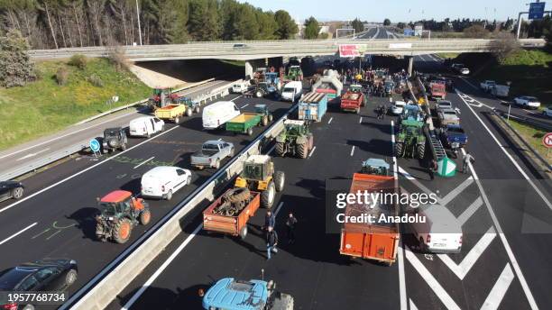 An aerial view of the A9 motorway connecting France and Spain blocked by farmers with their tractors while farmers protest to draw attention to their...