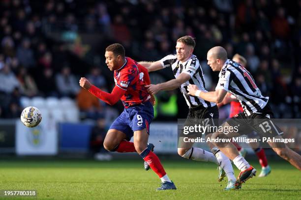 Rangers' Cyriel Dessers attempts to break clear from St Mirren's Marcus Fraser and Alex Gogic during the cinch Premiership match at The SMISA...