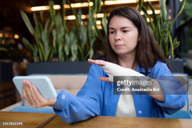 portrait of woman with injured hand,elastic bandage on the wrist. - ace bandage stock pictures, royalty-free photos & images