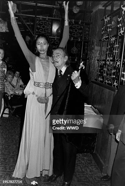 Salvador Dali, pictured with model Donyale Luna, hosts a dinner party at Trader Vic's restaurant in New York City, on March 16, 1975.