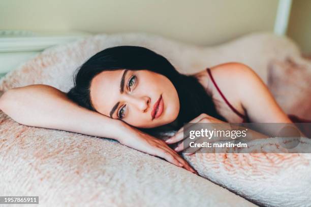 woman staying home and dreaming about the nice weather outside - woman thinking stock pictures, royalty-free photos & images