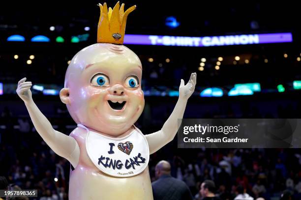 The New Orleans Pelicans King Cake Baby stands on the court during the fourth quarter of an NBA game between the against the New Orleans Pelicans and...