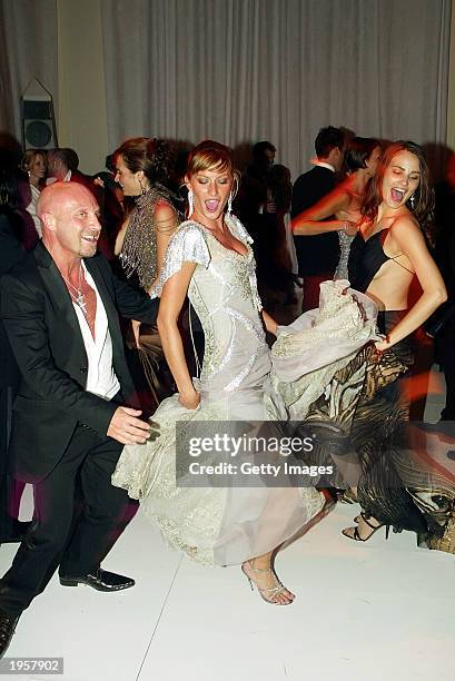 Model Gisele Bundchen and designer Domenico Dolce dance during the Costume Institute Benefit Gala sponsored by Gucci April 28, 2003 at The...