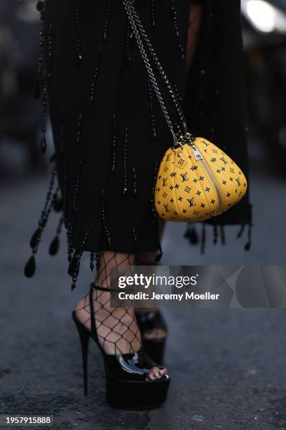 Corina Mihaila Larpin seen wearing Dolce Gabbana black beads fringed long coat, black fishnet tights, Louis Vuitton x Yayoi Kusama yellow leather...
