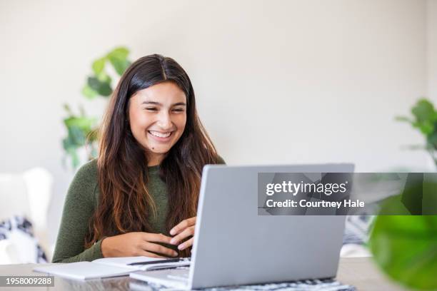 en su residencia, una madre guía a su estudiante de secundaria a través de una tarea virtual usando la computadora portátil. - estudiante de secundaria fotografías e imágenes de stock