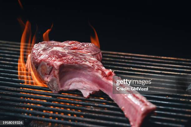tomahawk steak on bbq grill - tomahawk stock pictures, royalty-free photos & images