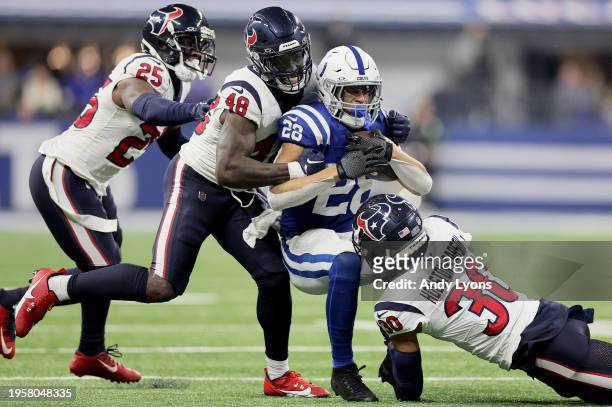 Desmond King II , Christian Harris and DeAndre Houston-Carson of the Houston Texans tackle Jonathan Taylor of the Indianapolis Colts at Lucas Oil...
