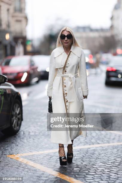 Corina Mihaila Larpin seen wearing Linda Fargo black sunglasses, Stefere Jewelry black / silver diamond earrings / hoops, Schiaparelli cream white...