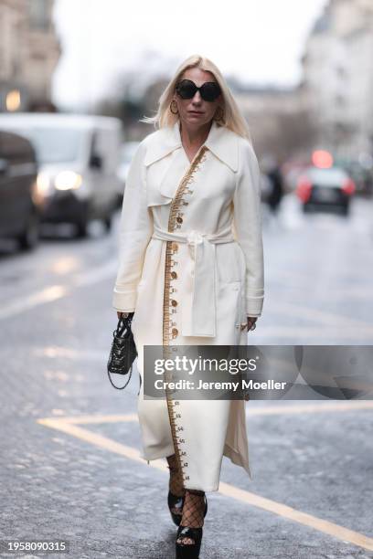 Corina Mihaila Larpin seen wearing Linda Fargo black sunglasses, Stefere Jewelry black / silver diamond earrings / hoops, Schiaparelli cream white...