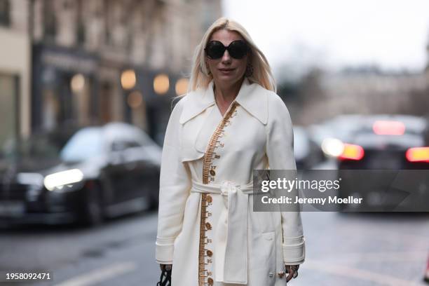 Corina Mihaila Larpin seen wearing Linda Fargo black sunglasses, Stefere Jewelry black / silver diamond earrings / hoops, Schiaparelli cream white...