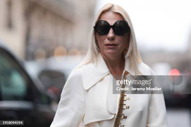 Corina Mihaila Larpin seen wearing Linda Fargo black sunglasses, Stefere Jewelry black / silver diamond earrings / hoops, Schiaparelli cream white...