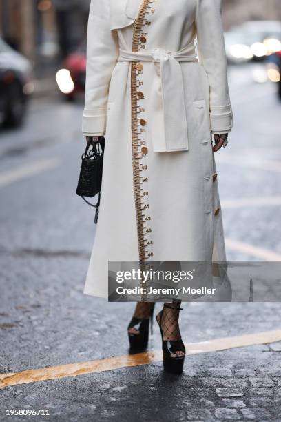 Corina Mihaila Larpin seen wearing Stefere Jewelry black / silver diamond rings, Schiaparelli cream white long wool coat with gold details, black...