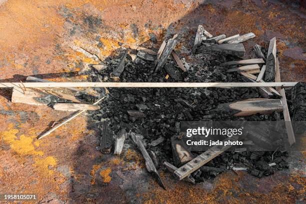 rusty metal fire pit with burnt wood - glowing hot steel stock pictures, royalty-free photos & images