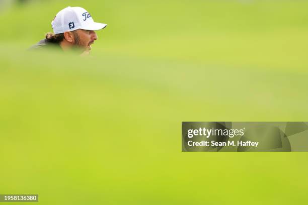 Max Homa of the United States lines up a putt on the third green during the first round of the Farmers Insurance Open on the Torrey Pines South...