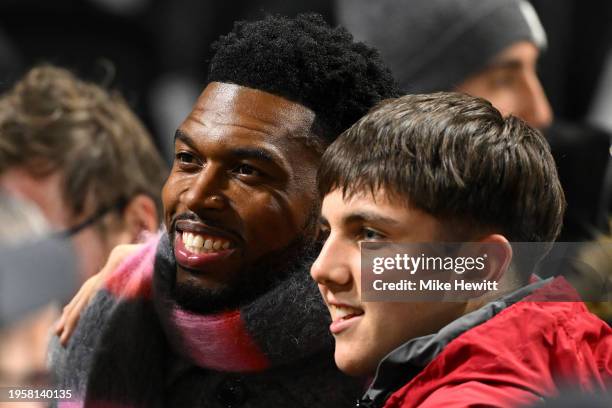 Former Liverpool player Daniel Sturridge poses for a photo with a fan prior to the Carabao Cup Semi Final Second Leg match between Fulham and...