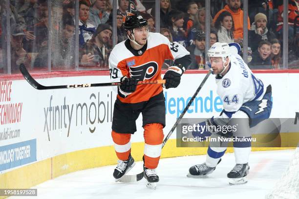 Cam Atkinson of the Philadelphia Flyers skates past Calvin de Haan of the Tampa Bay Lightning at the Wells Fargo Center on January 23, 2024 in...