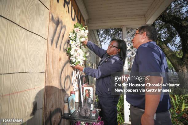 Former Houston Police Officer Kathy Swilley and We The People Founder Hai Bui attempt to hang a wreath on a house at 7815 Harding Street before a...
