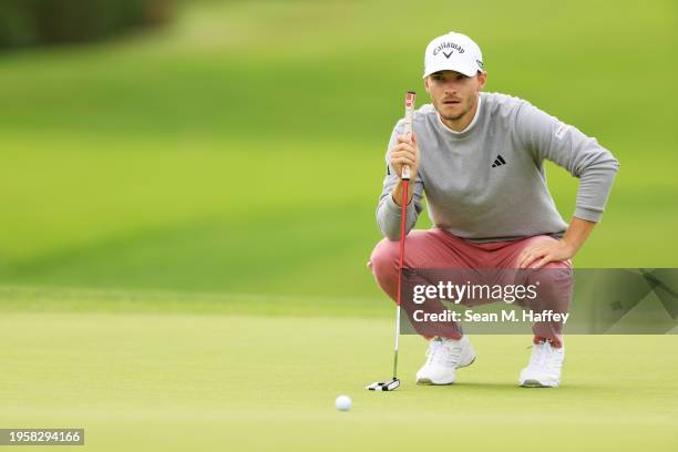 Nicolai Hojgaard of Denmark lines up a putt on the sixth green during the first round of the Farmers Insurance Open on the Torrey Pines South Course...