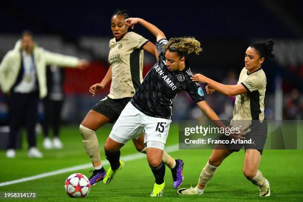 Chasity Grant of Ajax is challenged by Marie-Antoinette Katoto and Sakina Karchaoui of Paris Saint-Germain during the UEFA Women's Champions League...