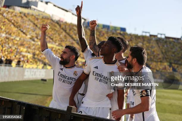 Real Madrid's French defender Aurelien Tchouameni celebrates with teammates after scoring his team's second goal during the Spanish league football...
