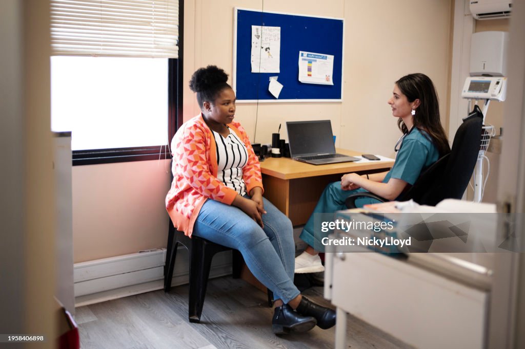 Patient talking with her doctor during an appointment in her office