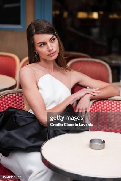 Mara Lafontan wears white maxi dress with black ruffled details, outside Stephane Rolland, during the Haute Couture Spring/Summer 2024 as part of...