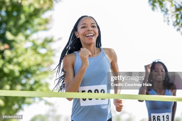 people from different walks of life unite to run a 5k marathon, raising funds for a charitable cause. - race for life stockfoto's en -beelden