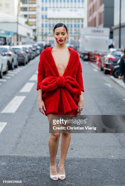 Cindy Kimberly with kiss lip make up wears red dress outside Viktor&Rolf during the Haute Couture Spring/Summer 2024 as part of Paris Fashion Week on...