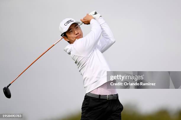 Michael Kim of the United States hits his shot from the 18th tee during the first round of the Farmers Insurance Open on the Torrey Pines North...