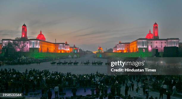 Visitors at the Vijay Chowk in the backdrop of illuminated Raisina Hill after full dress rehearsal for the upcoming Beating Retreat ceremony, on...