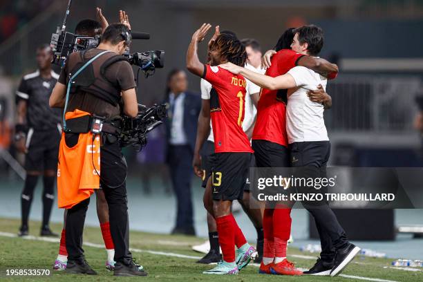 Angola's defender To Carneiro celebrates with Angola's Portugese coach Pedro Goncalves after their victory at the end of the Africa Cup of Nations...