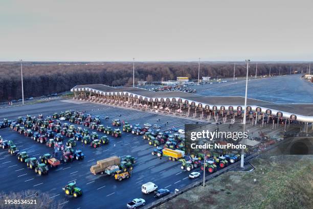 Aerial view of protesting farmers blocking the A10 highway with tractors during a protest against taxation and declining income, near the Péage de...