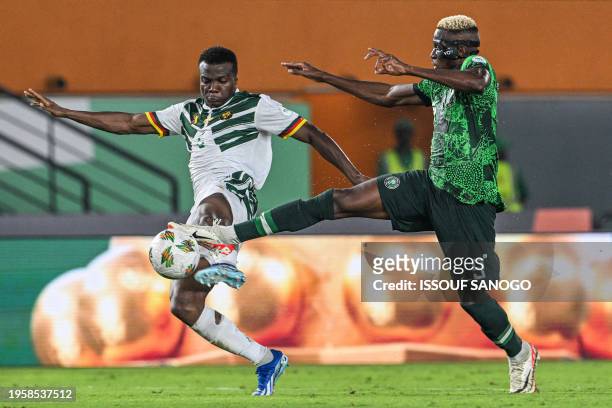 Nigeria's forward Victor Osimhen fights for the ball with Cameroon's defender Nouhou Tolo during the Africa Cup of Nations 2024 round of 16 football...