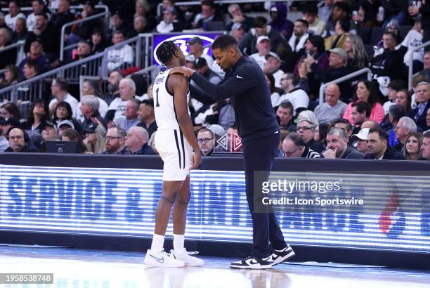 Providence Friars head coach Kim English speaks with Providence Friars guard Jayden Pierre during the college basketball game between Georgetown...