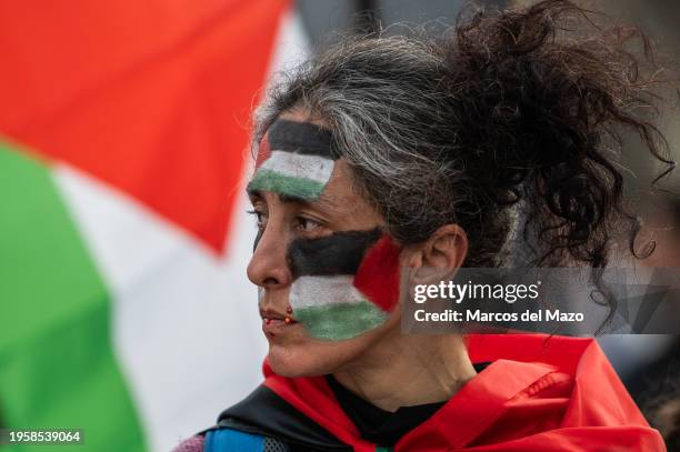Woman with Palestinian flags painted on her face protesting during a demonstration in support of the Palestinian people. Thousands of people have...