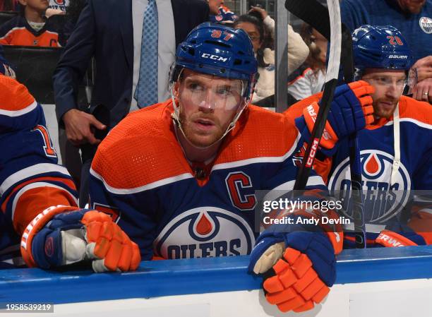 Connor McDavid of the Edmonton Oilers looks on from the bench before the game against the Nashville Predators at Rogers Place on January 27 in...