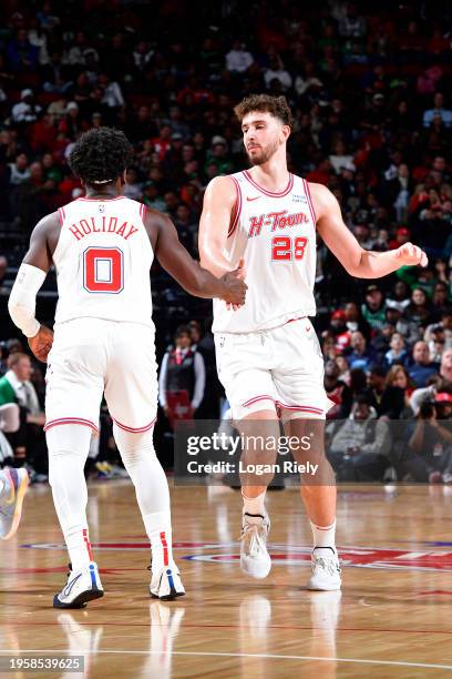 Aaron Holiday of the Houston Rockets and Alperen Sengun of the Houston Rockets high five during the game against the Boston Celtics on January 21,...