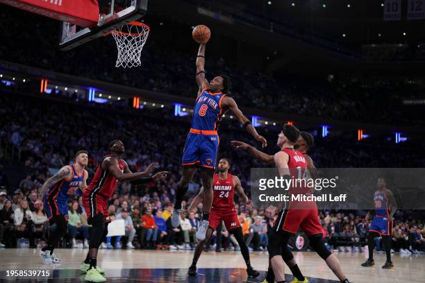 Anunoby of the New York Knicks dunks the ball past Bam Adebayo, Haywood Highsmith, and Tyler Herro of the Miami Heat in the second half at Madison...