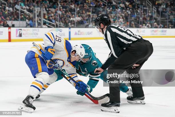 Tomas Hertl of the San Jose Sharks takes a face-off against Peyton Krebs of the Buffalo Sabres in the first period at SAP Center on December 27, 2024...