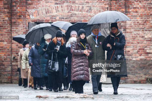 Holocaust survivors and their relatives attend a wreath and candles lying ceremony in front of the Death Wall in the former Nazi German Auschwitz I...
