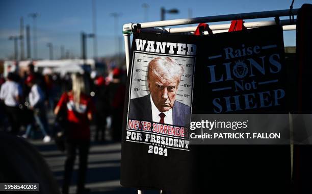 Merchandise with the mugshot of former US President and 2024 presidential hopeful Donald Trump is displayed outside a Commit to Caucus Rally in Las...