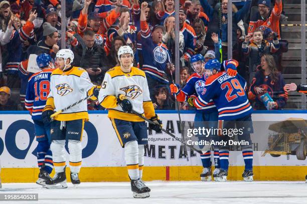 Connor McDavid of the Edmonton Oilers celebrates after scoring his third period goal against the Nashville Predators with teammates Leon Draisaitl...