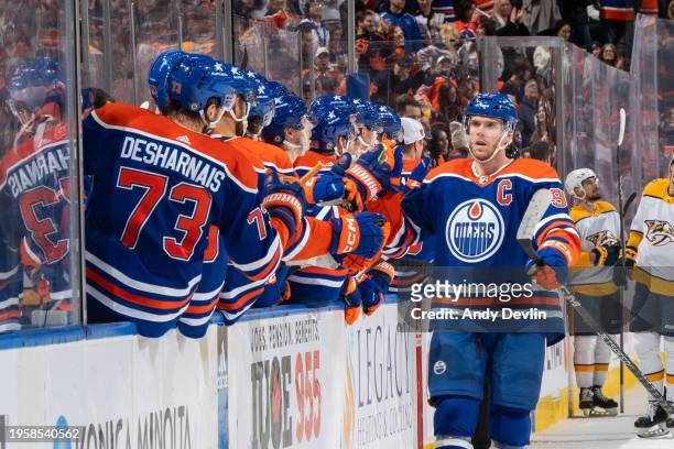 Connor McDavid of the Edmonton Oilers celebrates after scoring his third period goal against the Nashville Predators with his teammates at the bench...